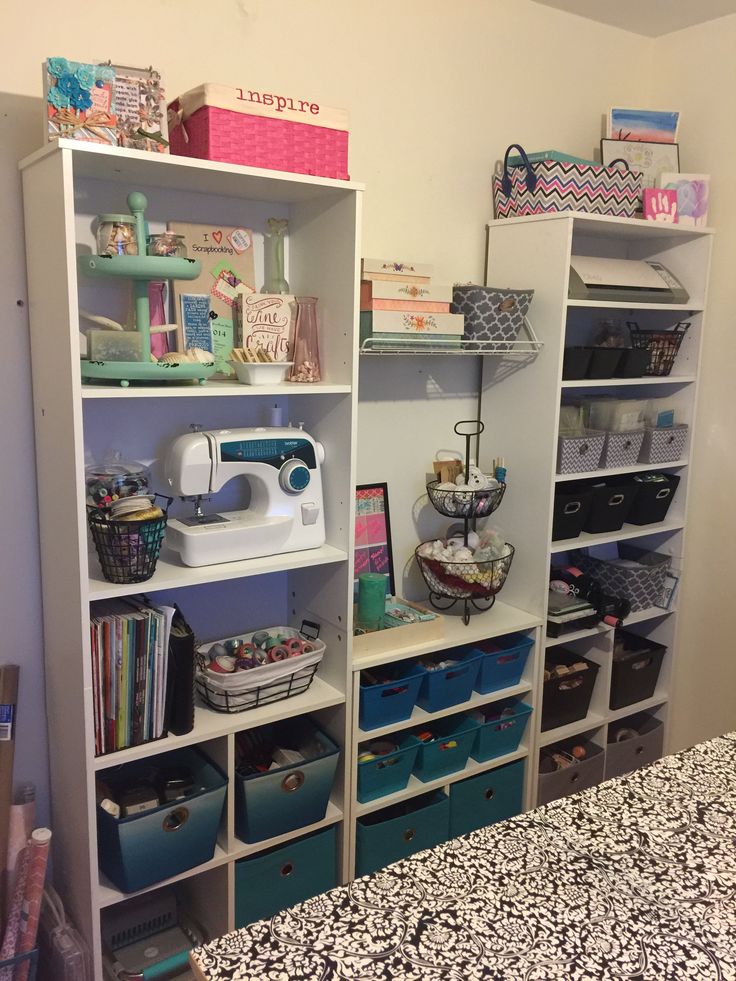 a sewing machine is sitting on top of a shelf in a room with many crafting supplies