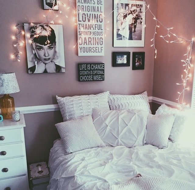 a bedroom with lights and pictures on the wall