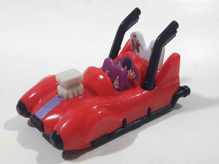 a red toy car sitting on top of a white table