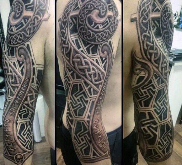 a man's arm with an intricate tattoo design on the sleeve and shoulder, in black