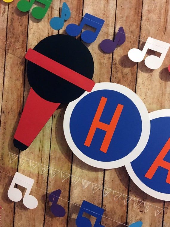 a wooden table topped with paper cutouts and musical notes