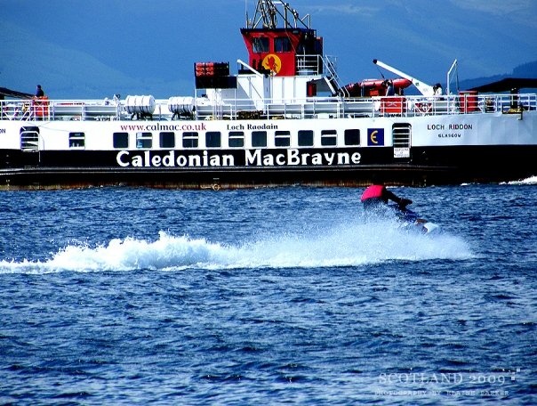 a person water skiing in front of a boat