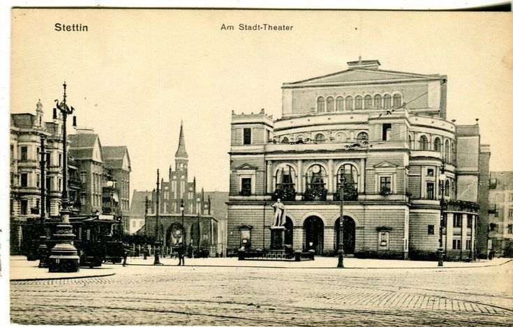 an old black and white photo of a building in the middle of a town square