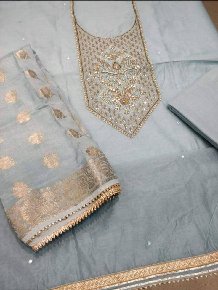 Item Overview ATHARVA Hand Embroidered Salwar Kameez w/Beautiful Embroidered Neck Grey/Banarsi Silk Dupatta/Latkan Tassel/Wedding/Bridal Trousseau Dno. CH1415 Fabric: * Shirt Chanderi Silk in Grey - 2.5 Mts, with Embroidered Neck * Dupatta: Banarsi Silk Dupatta - 2.5 Mts - (Motifs may wary) * Bottom Santoon Silk 2.5 Mts. Excusive Hand Embroidered Party Wear Punjabi Suit. Customization: * Fabrics Customization: Designs Can be made in different Fabrics. * Color Customization: Designs Can be made i Dupatta Latkan, Bridal Trousseau, Embroidered Salwar, Ladies Suit, Indian Salwar Kameez, Patiala Salwar, Silk Dupatta, Punjabi Suits, Beautiful Embroidery