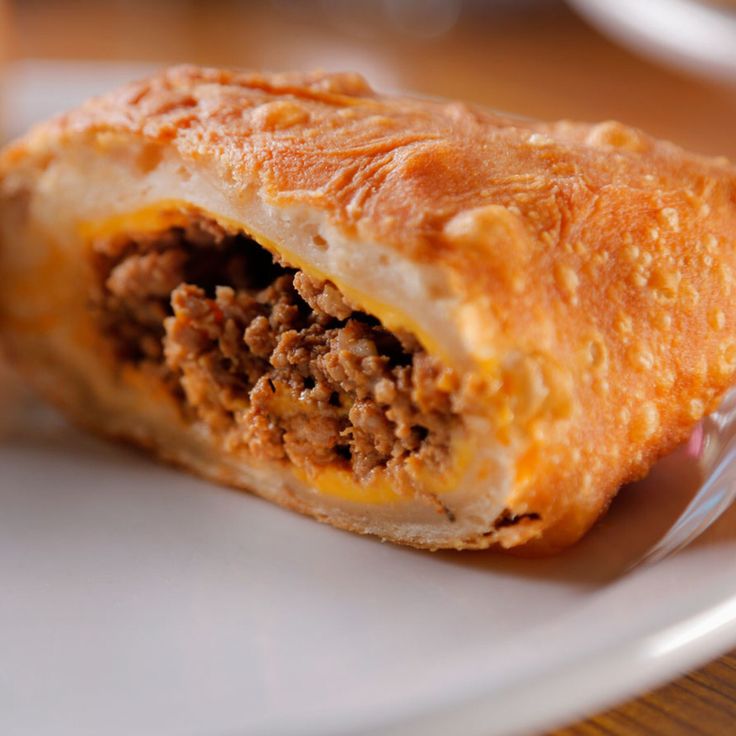 a close up of a pastry on a plate with a fork and spoon in it