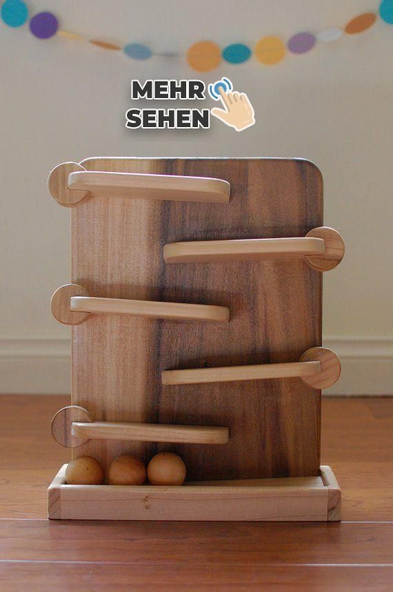 a wooden cutting board with several pieces of wood on it and balls in the middle