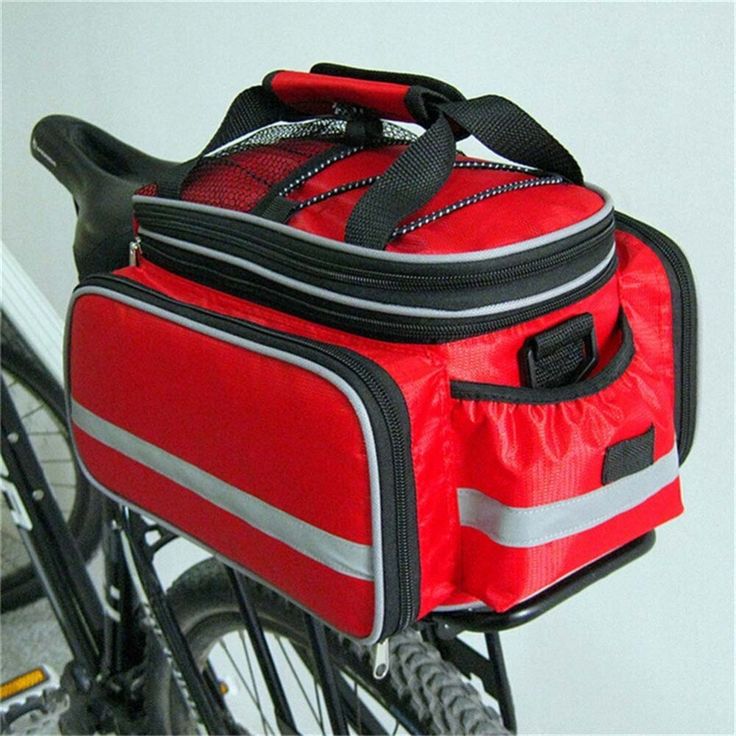 a bicycle with a red bag on the front and back seat, attached to it's handlebars