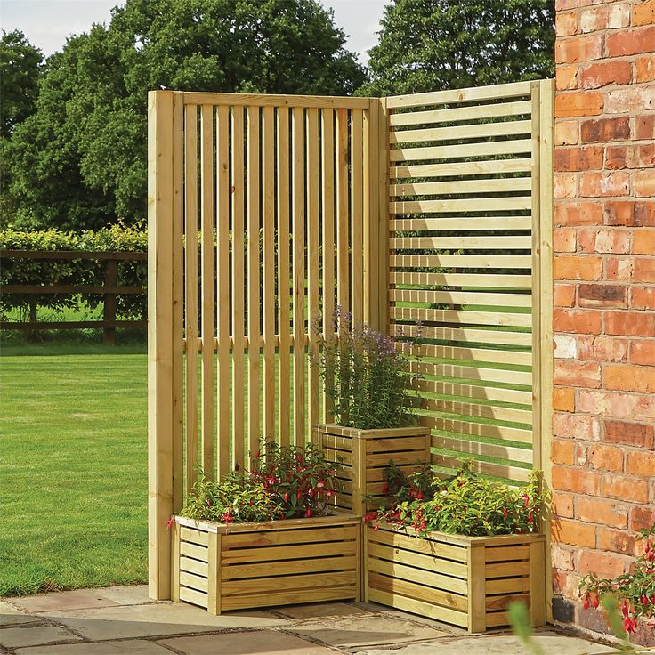 a wooden trellis next to a brick wall with potted plants on the side