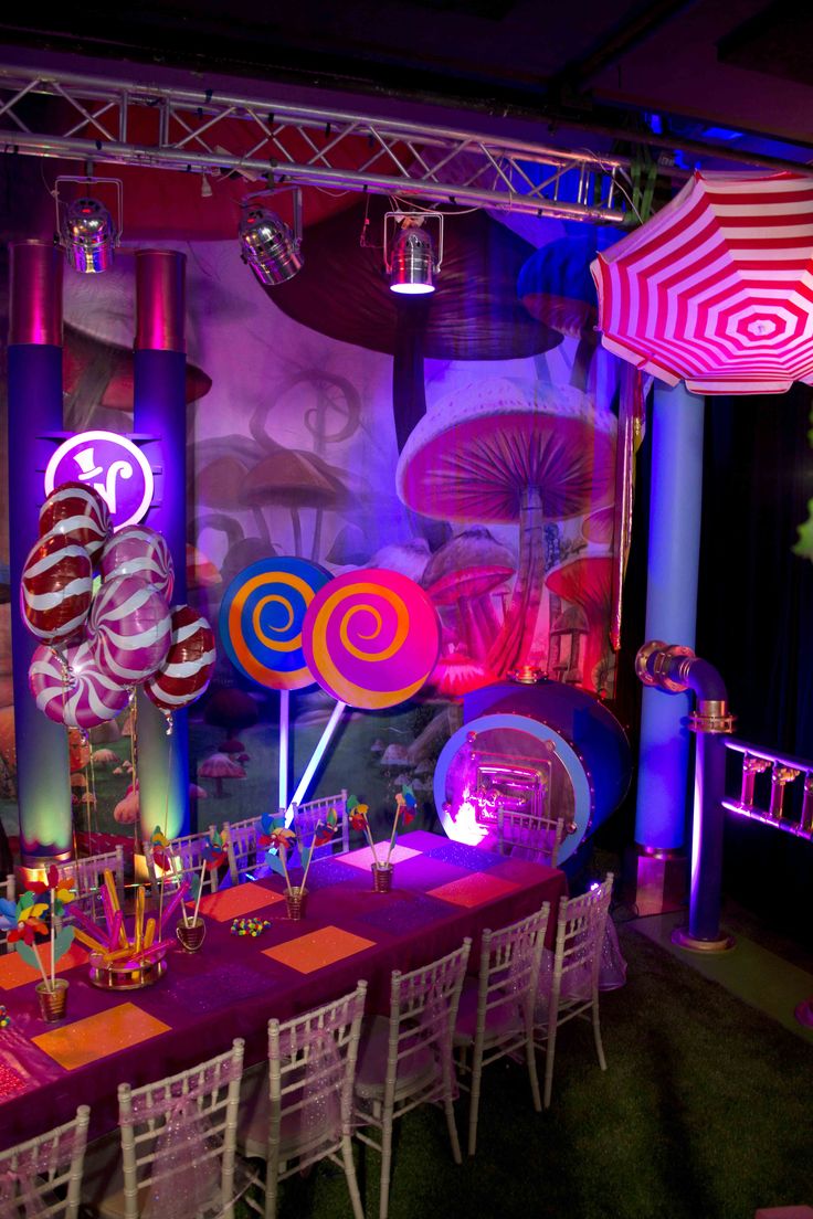 an image of a party setting with candy and umbrellas on the stage set up