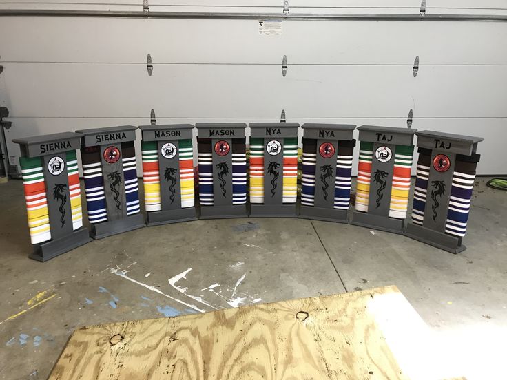 a row of hockey socks sitting on top of a wooden floor next to a wall