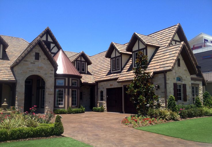 a large house with lots of windows and roofing on it's front lawn