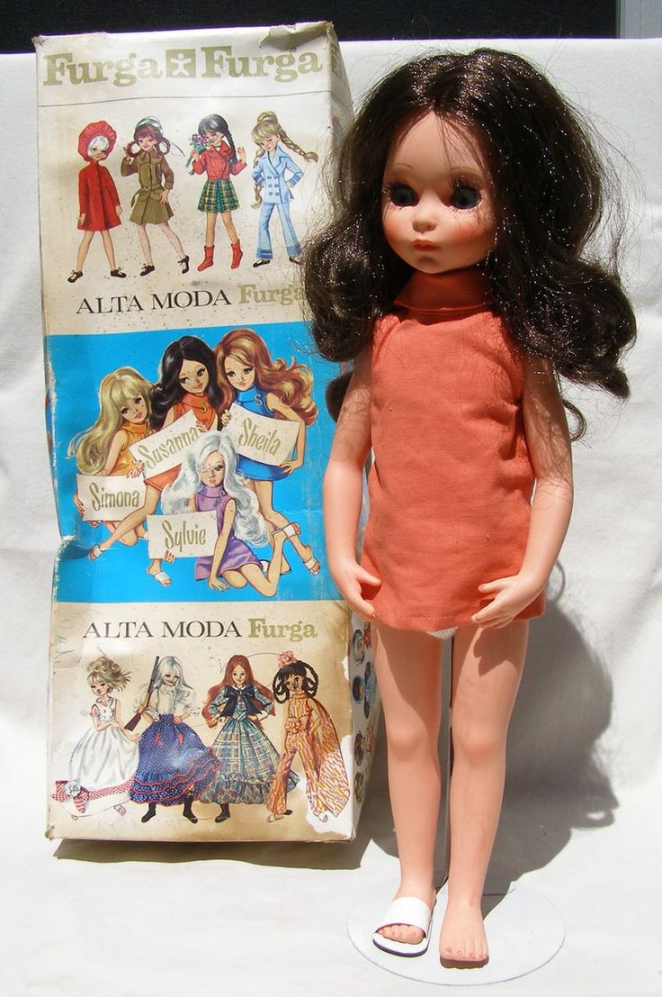 a doll is standing next to an old fashion book and it looks like she's been made