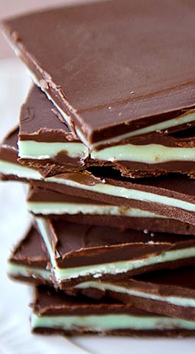 a stack of chocolate bars sitting on top of a white plate