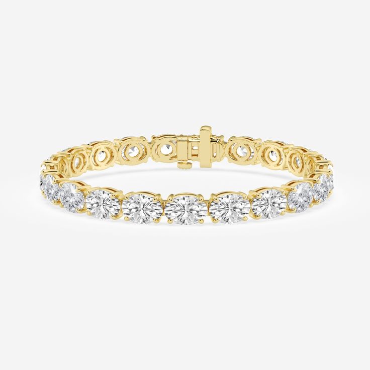 Elegance and versatility meet in perfect harmony with this chic oval east-west bracelet. A scintillating row of oval cut diamonds, boldly showcased in a horizontal setting, creates a mesmerizing display of timeless beauty. Enjoy endless sparkle during any occasion with this dazzling design! Gold Oval Tennis Bracelet For Wedding, Elegant Yellow Gold Diamond Bracelet With Brilliant Cut, Elegant Yellow Gold Brilliant Cut Diamond Bracelet, Elegant White Gold Oval Link Bracelets, Elegant Oval Link Diamond Cut Bracelets, Elegant Oval Link Diamond-cut Bracelets, Oval Diamond Cut Wedding Bracelet, White Oval Wedding Bracelet, Oval Brilliant Cut Tennis Bracelet For Wedding