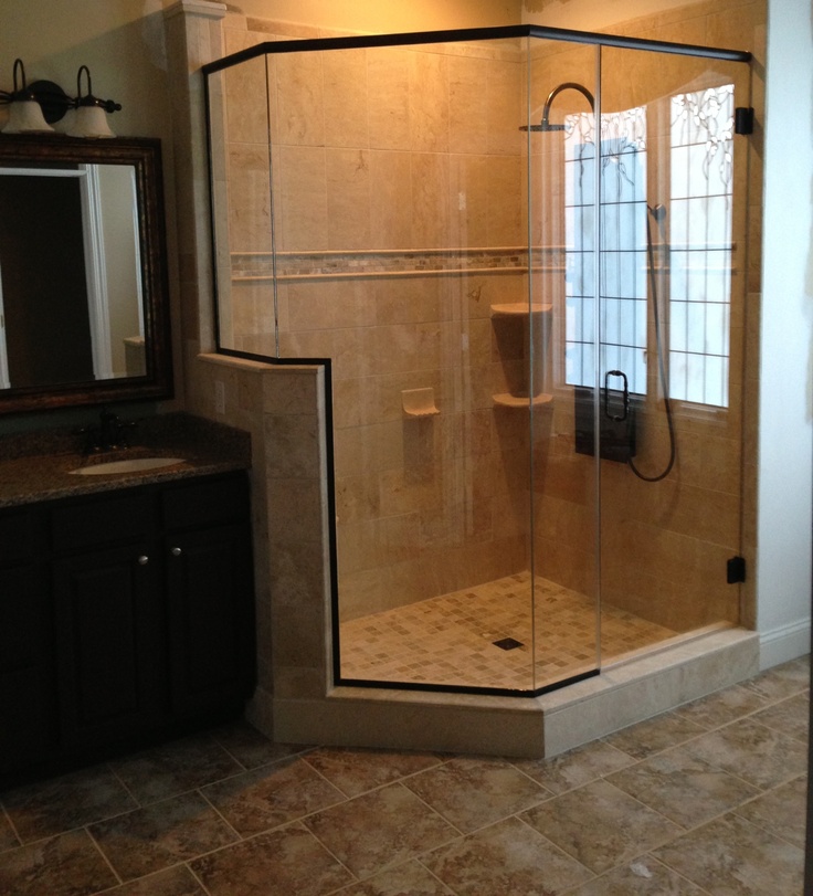 a bathroom with a walk in shower next to a sink