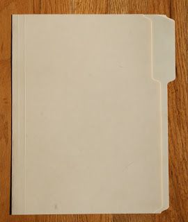 a white folder sitting on top of a wooden table