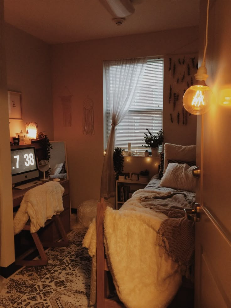 a bed room with a neatly made bed next to a window