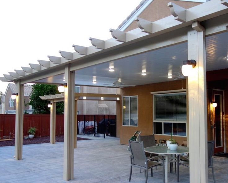 an outdoor patio with table, chairs and lights