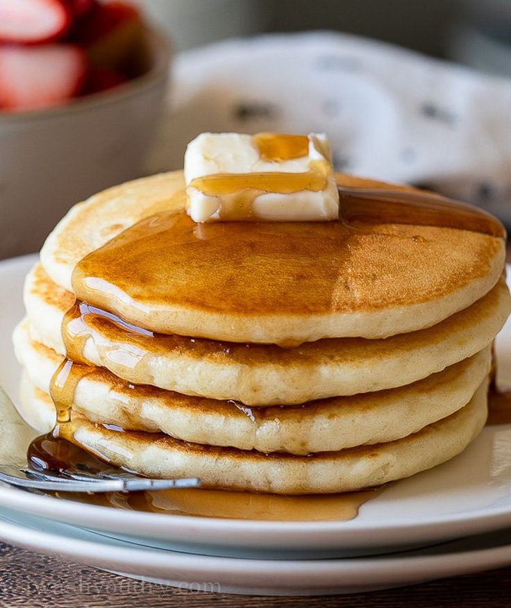 a stack of pancakes with butter and syrup on top