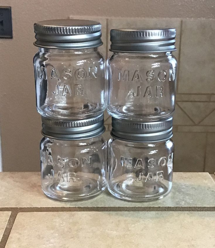 three mason jars sitting on top of a counter