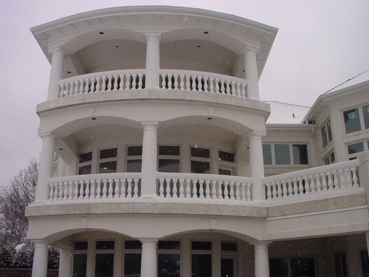 a large white building with balconies and windows