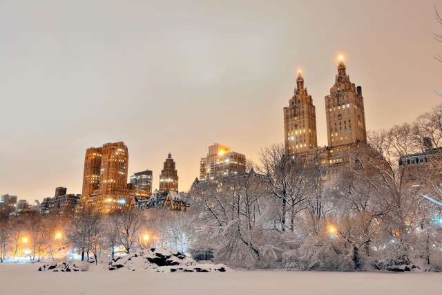 the city is covered in snow at night