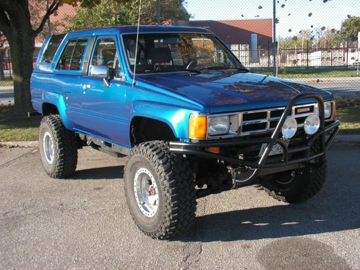 a blue pick up truck parked in a parking lot