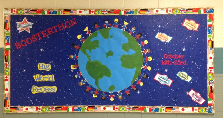 a bulletin board with stickers on it in a school gym area that has the earth surrounded by colorful pins and magnets