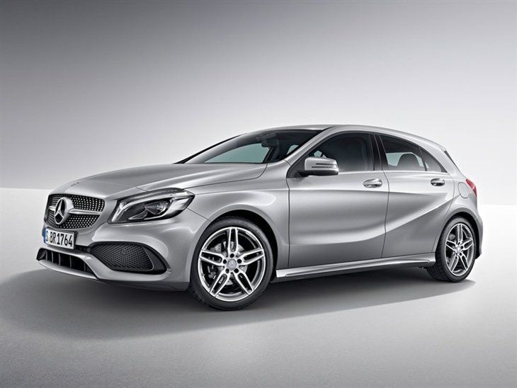 the front end of a silver mercedes benz cla parked in an empty room with white walls