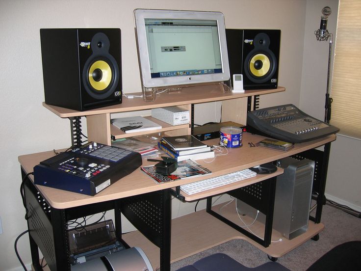 there is a desk with speakers and a computer on it