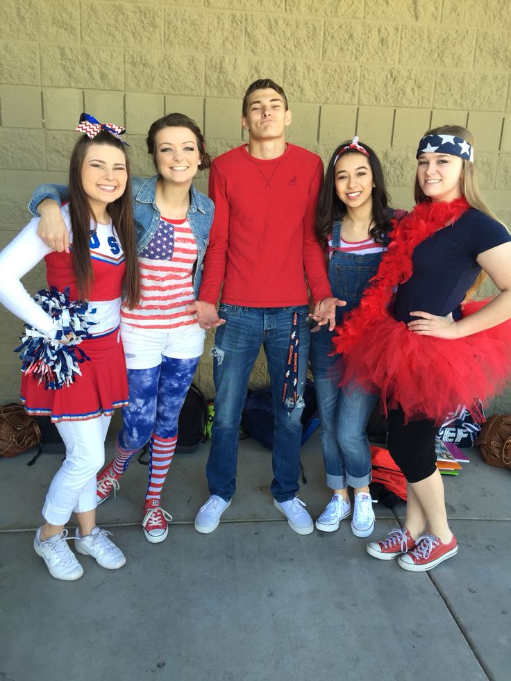 a group of people standing next to each other in front of a building wearing costumes