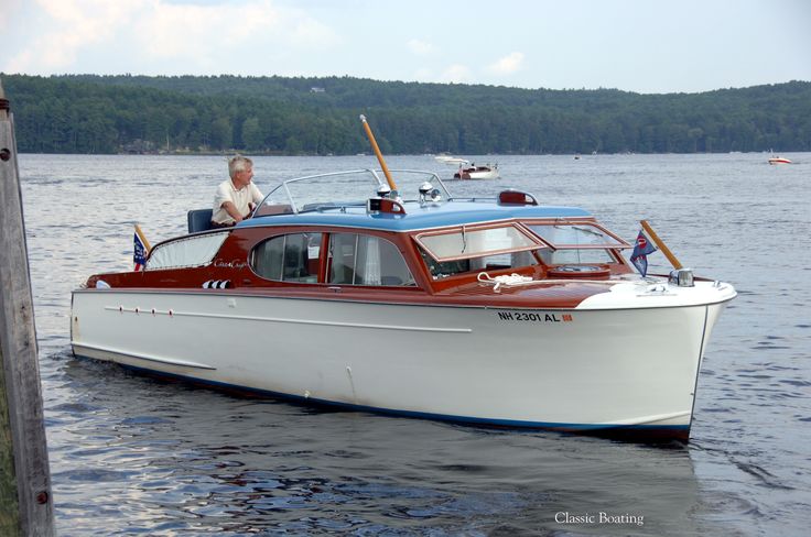 a man sitting on top of a white boat in the middle of a body of water