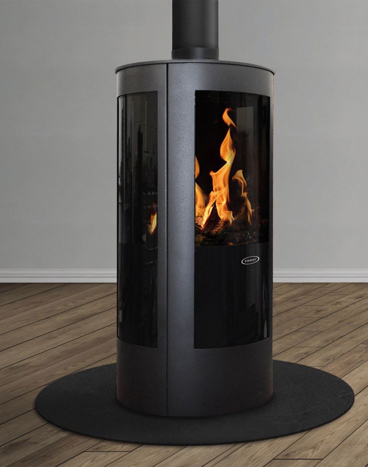 a wood burning stove in a room with hard wood flooring