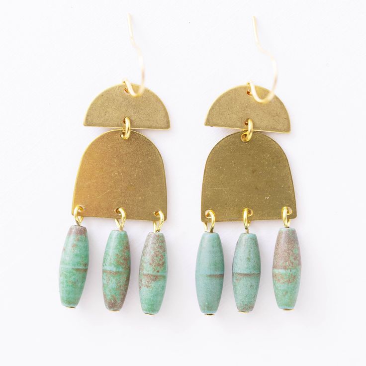 "A 1.5\" pair of earrings made of brass with beautiful natural Green Turquoise Magnesite stone beads. The ear wires are 24K gold plated. The details: 1.5\" long Brass Green Turquoise Magnesite stones 24K GP ear wires Handmade in our Burlington VT studio Shipped in a gift box."