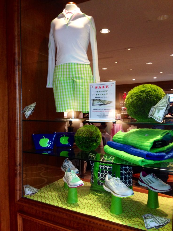 a display case with green and blue items in it's glass front window at a store