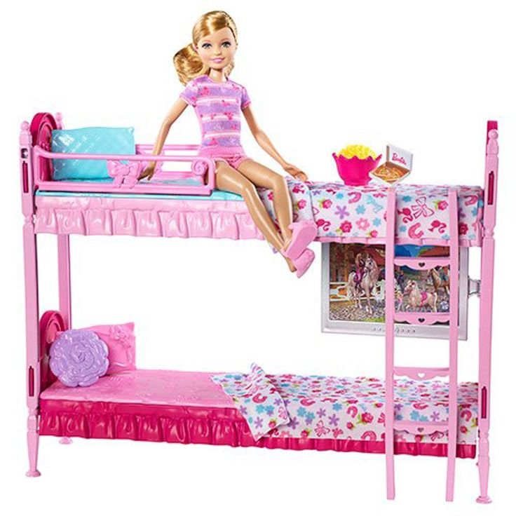 a barbie doll sitting on top of a bunk bed next to a table and chair