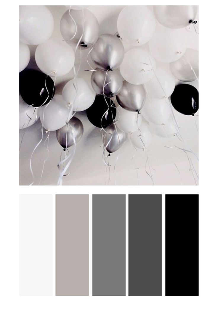 white and black balloons are floating in the air, with some grays on them