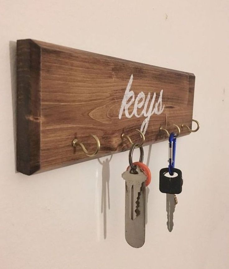 keys are hanging on a key holder that is attached to a wall