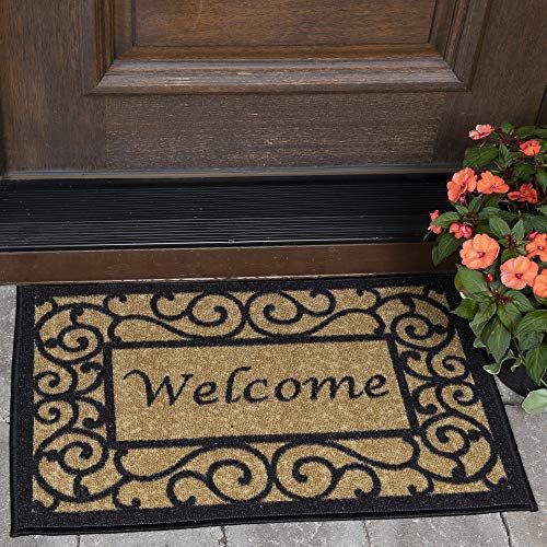 a welcome mat sitting next to a door