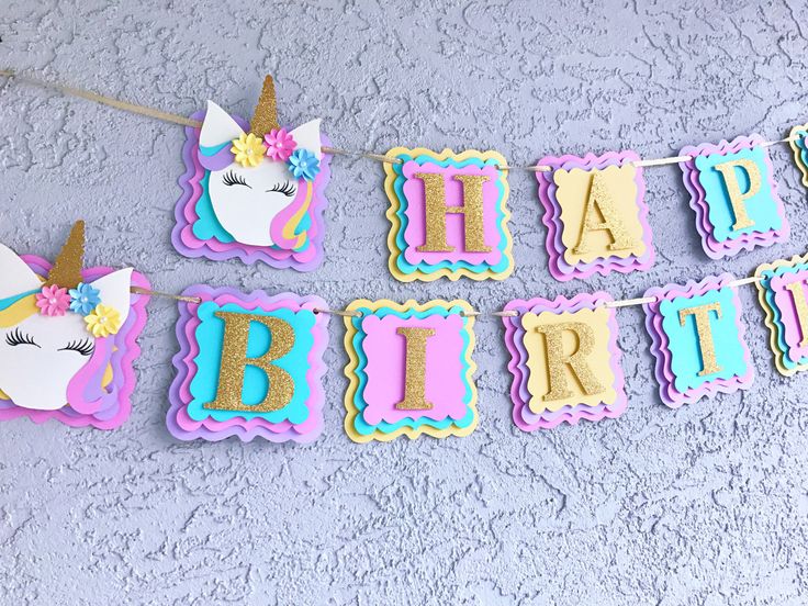 a birthday banner with unicorns on it