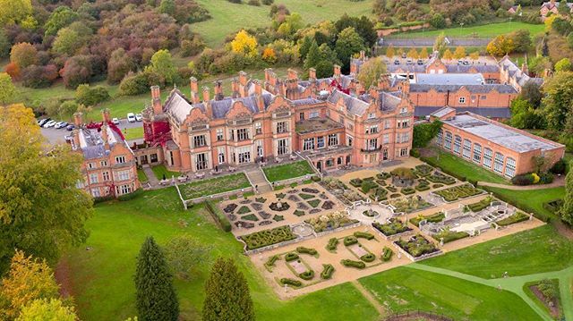 an aerial view of a large brick building surrounded by trees