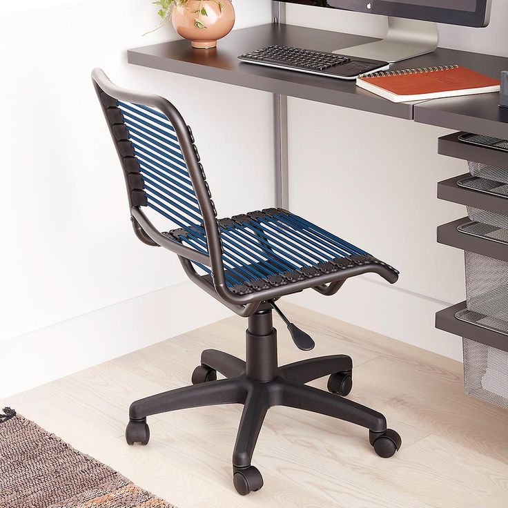 an office chair sitting in front of a desk with a computer on top of it