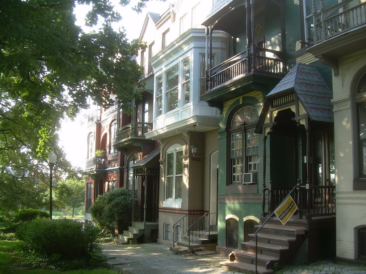 a row of multi - story houses with balconies on the first floor and second story