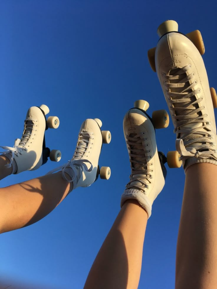 three people are standing with their feet on skateboards