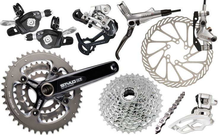 an assortment of bicycle parts including disc brakes, chain and sprocking gear on a white background