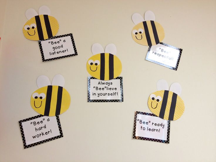 the bulletin board is decorated with pictures of bees and their name tags for each bee