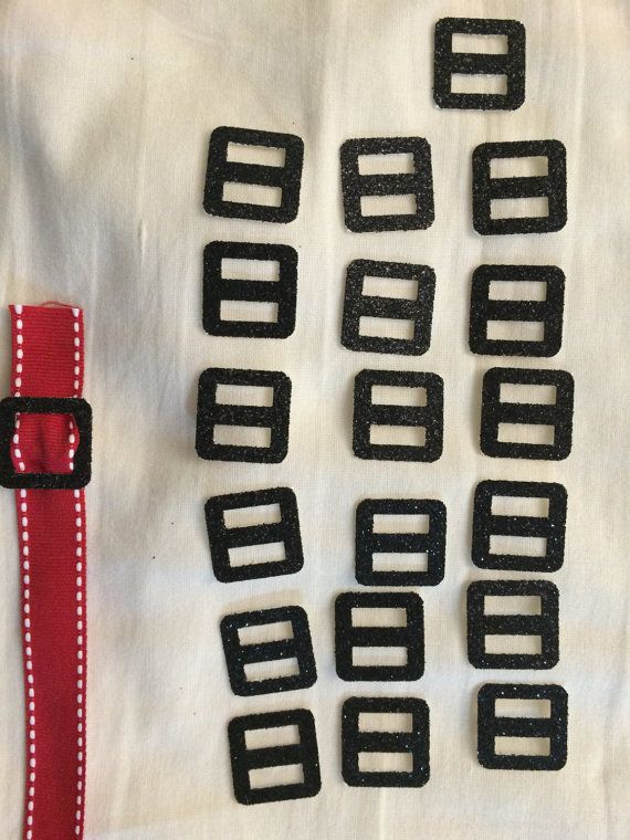 several pieces of black and red fabric with white stitching on them, including a belt