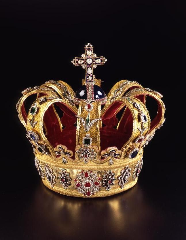 a gold crown with jewels and a cross on top