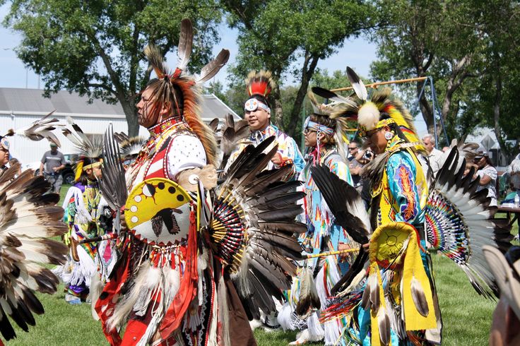 native american people in costume at an outdoor event