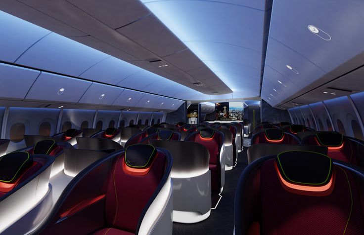 the interior of an airplane with red and white seats, blue ceilinging and windows